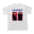 White t-shirt featuring two figures and the text ’SPARKS’ above them.