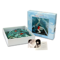 Jigsaw puzzle set featuring an album cover image and pieces in an open box.
